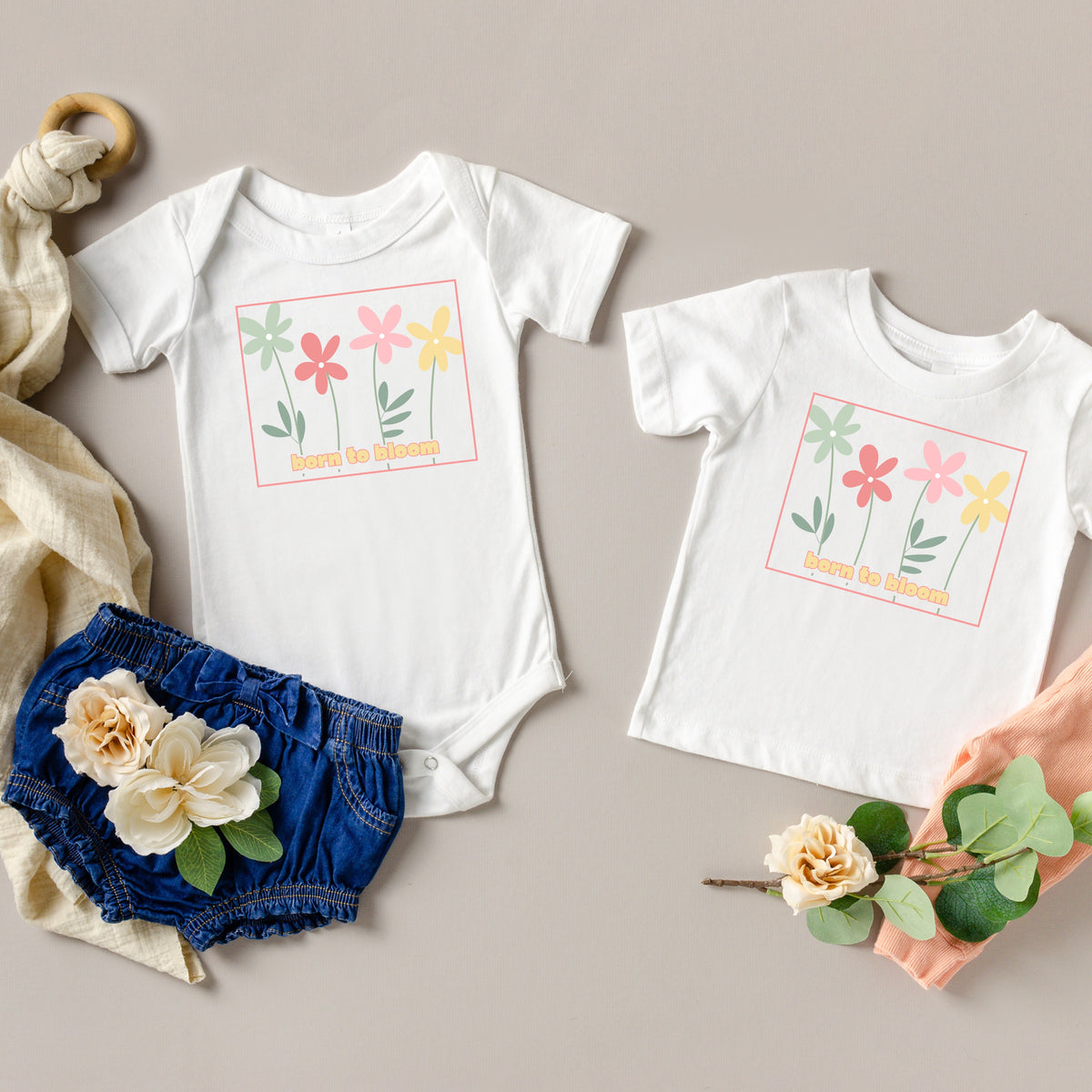 Born to Bloom infant bodysuit and toddler tee shown together with the colorful retro flower graphic.