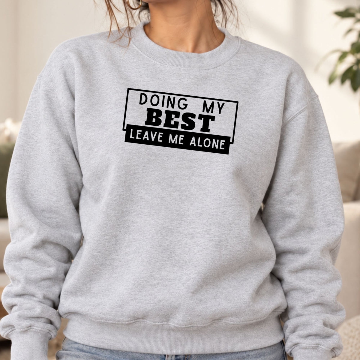 Woman wearing an ash Doing My Best Leave Me Alone adult crewneck sweatshirt