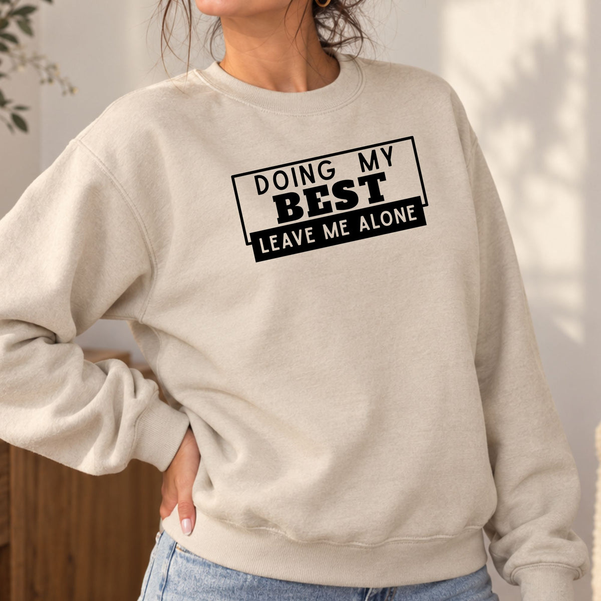 Woman wearing a sand Doing My Best Leave Me Alone adult crewneck sweatshirt