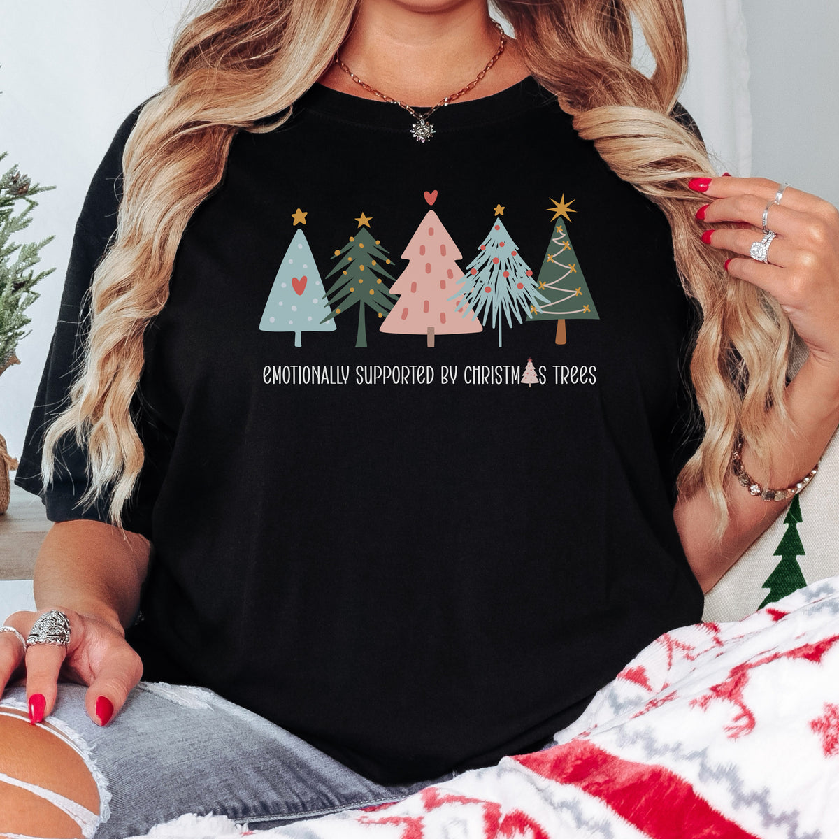 Emotionally Supported by Christmas Trees graphic tee in black, styled for Christmas