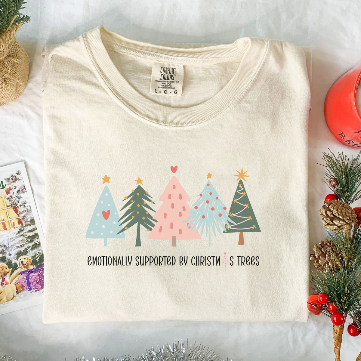 Emotionally Supported by Christmas Trees adult graphic tee in cream, front flat lay