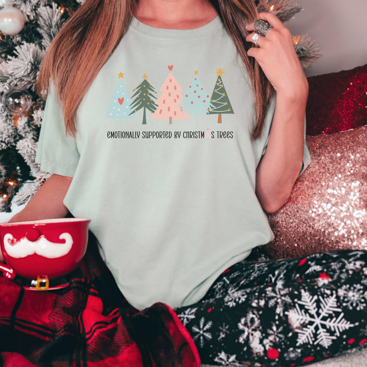 Emotionally Supported by Christmas Trees graphic tee in seafoam green, styled for Christmas