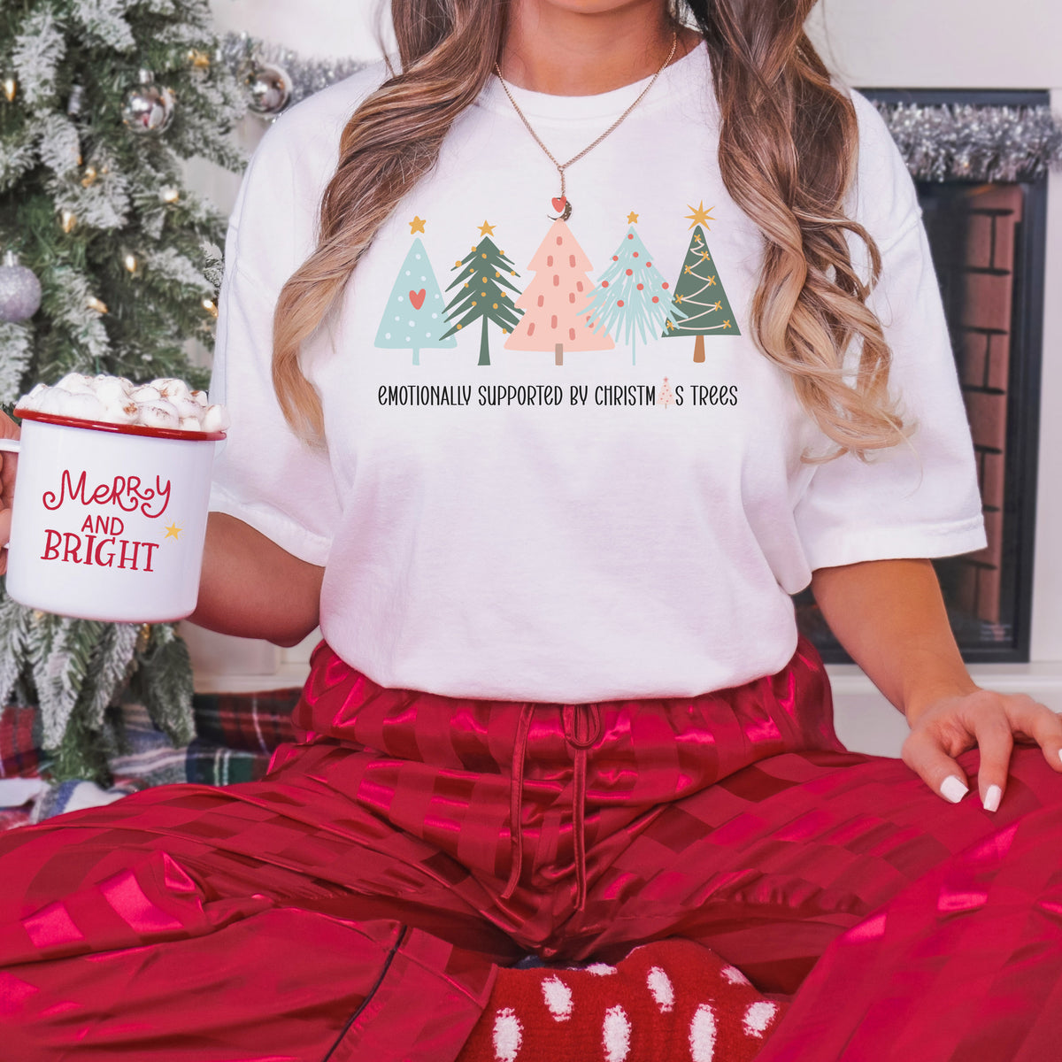 Emotionally Supported by Christmas Trees graphic tee in white, styled for Christmas
