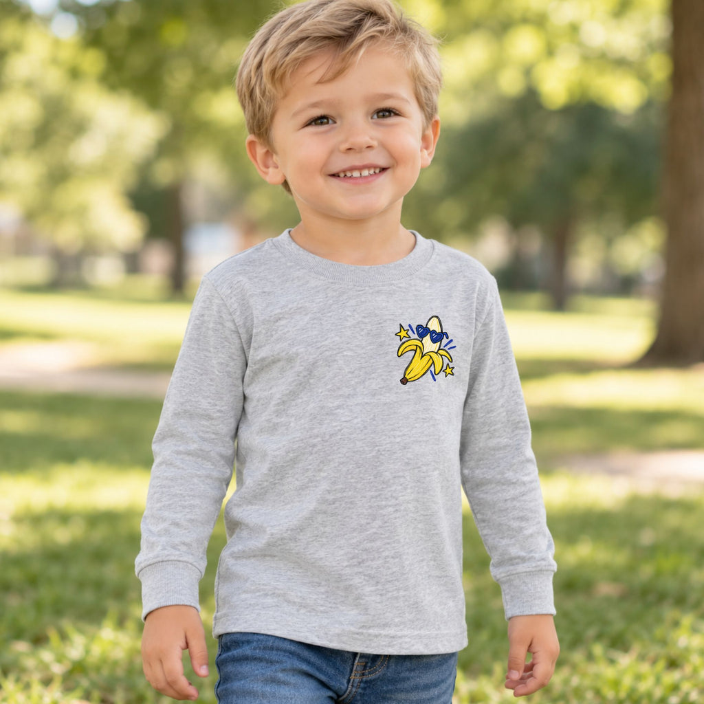 Toddler wearing a heather Go Bananas long sleeve tee, front view showing the banana left-chest design.