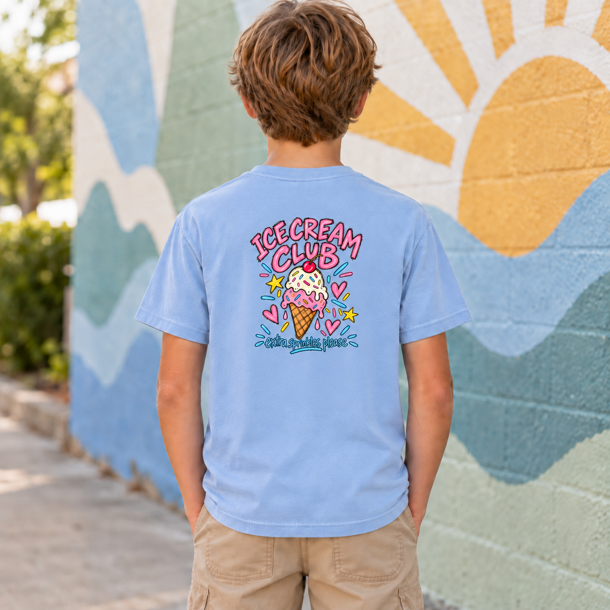 Youth wearing a chambray Ice Cream Club tee, back view showing the full ice cream cone design with “Extra Sprinkles Please.”