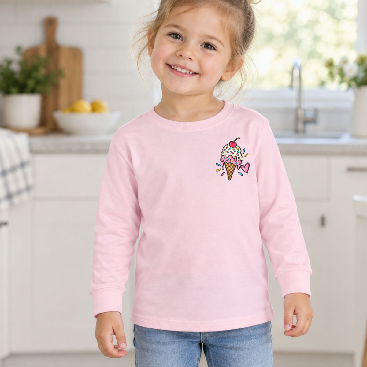 Girl wearing a pink Ice Cream Club toddler long sleeve tee, front view showing the ice cream left-chest design.