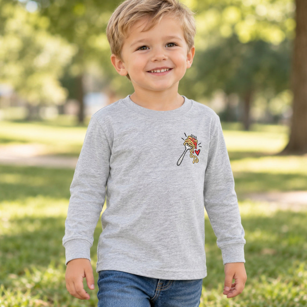 Boy wearing a heather No Regretti toddler long sleeve tee, front view showing the spaghetti left-chest design.