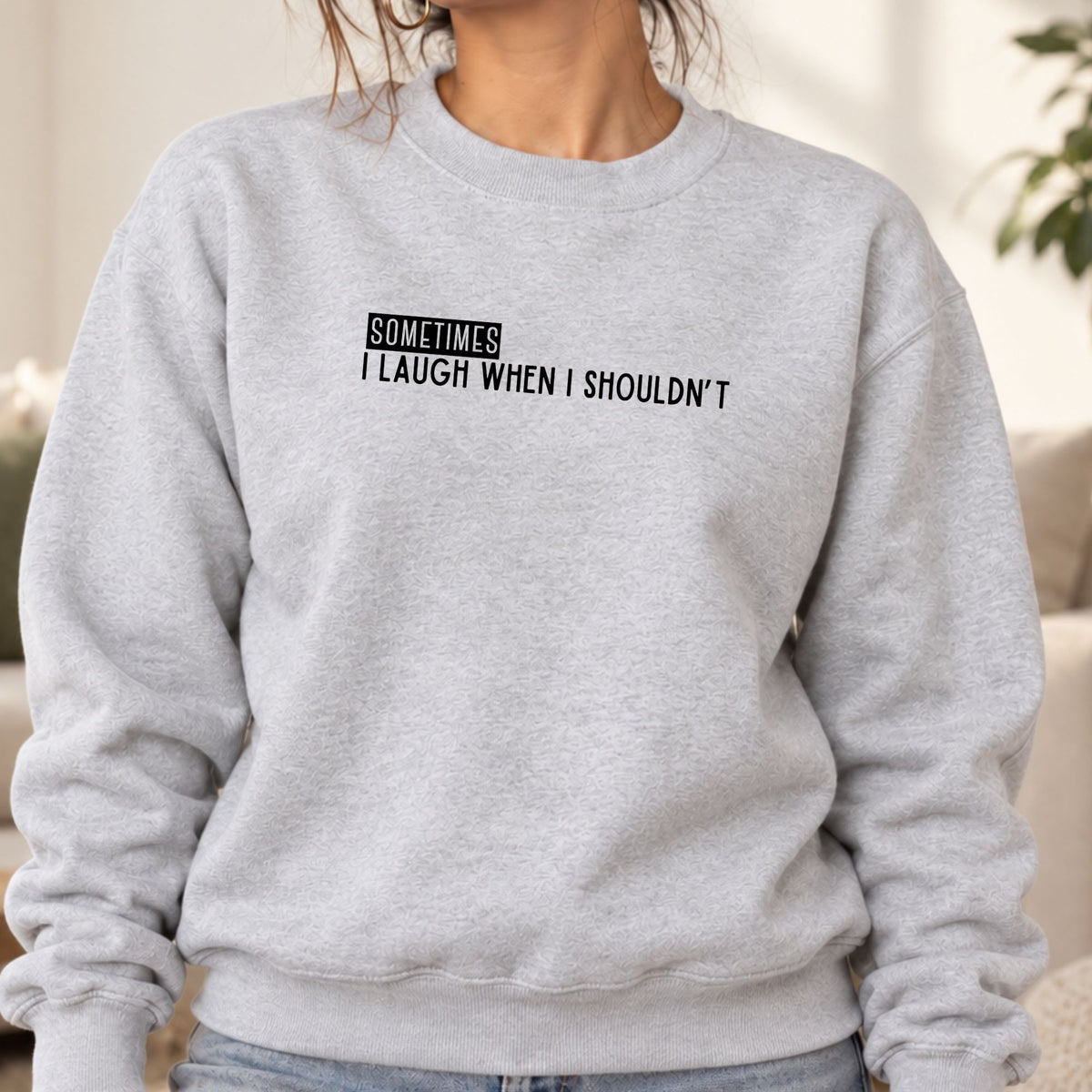 Woman wearing an ash Sometimes I Laugh When I Shouldn’t adult crewneck sweatshirt