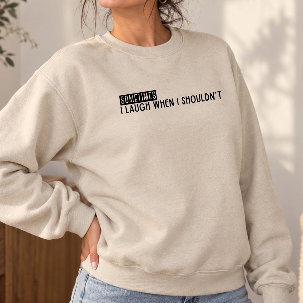 Woman wearing a sand Sometimes I Laugh When I Shouldn’t adult crewneck sweatshirt